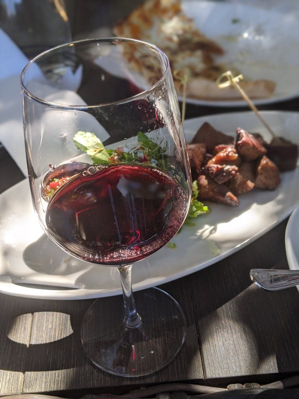 A glass of red wine with small plates at Roblar Winery in the Santa Ynez Valley near Santa Barbara