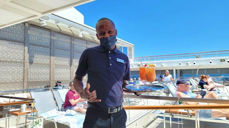 ray serving drinks by the pool on viking orion