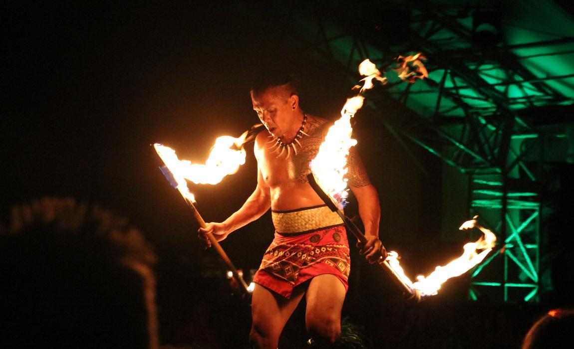 Fire dancer at a luau on Kauai during a cruise stop