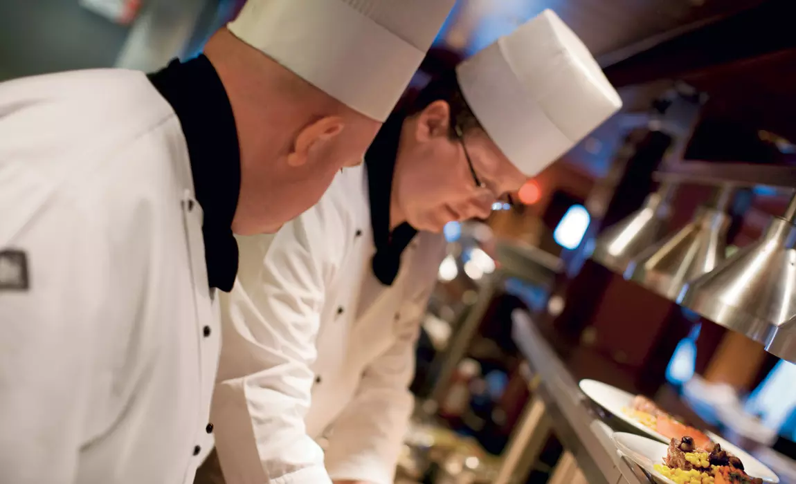 Norwegian Cruise Line chefs preparing a gluten free option at Cagney's Steakhouse