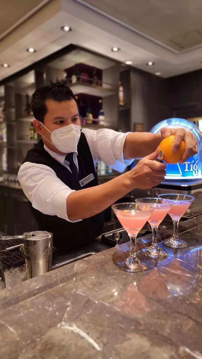 cruise bartender making cocktails on holland america line cruise ship