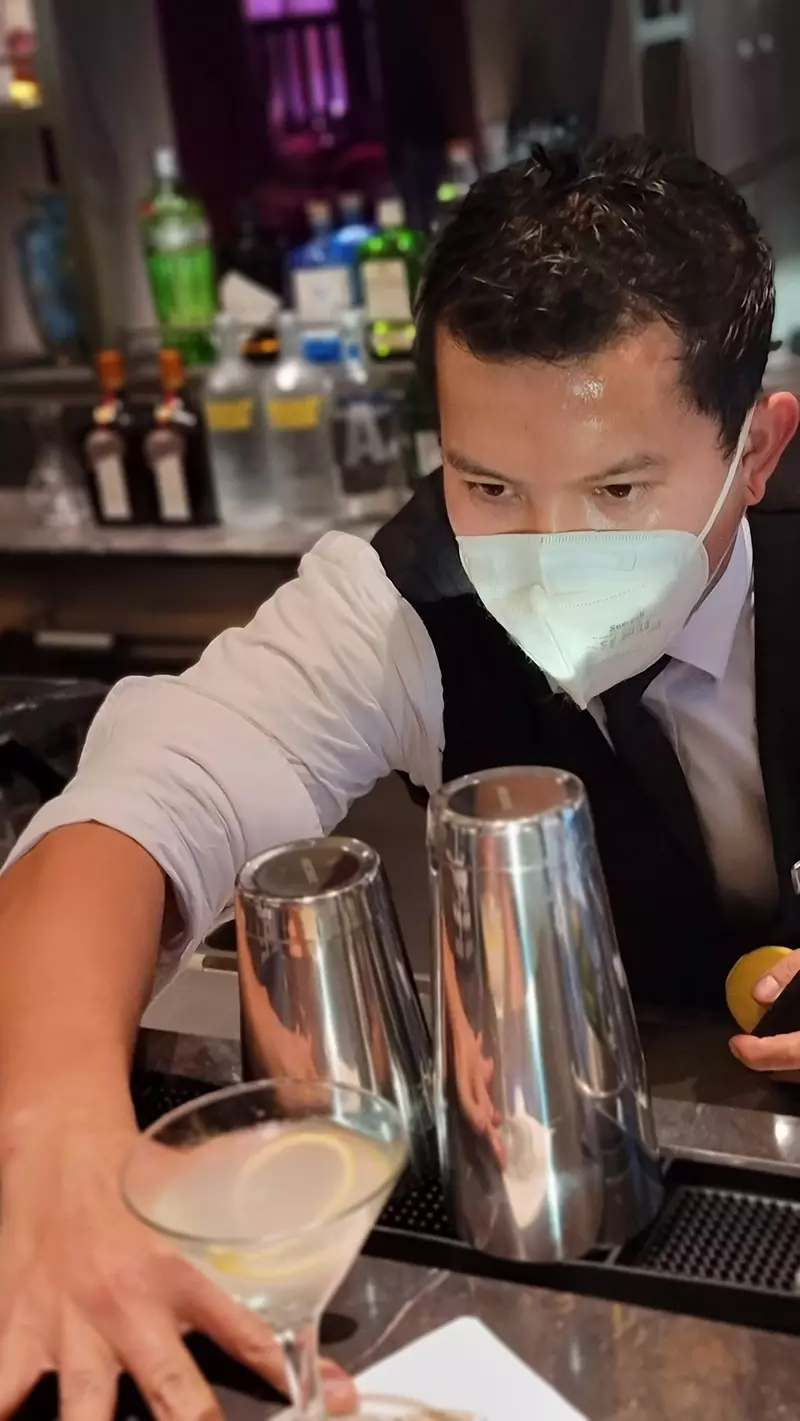 holland america line bartender on cruise ship making a martini