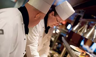 Norwegian Cruise Line chefs preparing a gluten free option at Cagney's Steakhouse